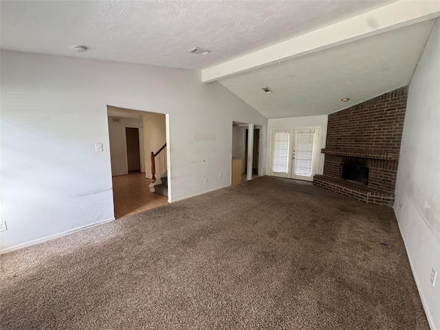 3 Ridgeline Ct, The Woodlands, TX 77381 - unfurnished living room featuring carpet flooring, stairs, and a fireplace