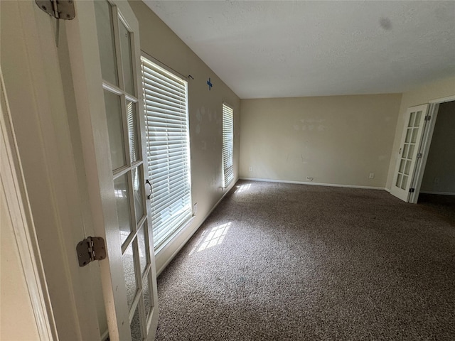 3 Ridgeline Ct, The Woodlands, TX 77381 - carpeted spare room with baseboards and a textured ceiling