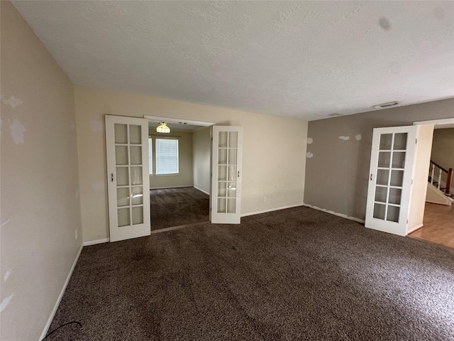3 Ridgeline Ct, The Woodlands, TX 77381 - carpeted spare room featuring french doors, a textured ceiling, and stairs