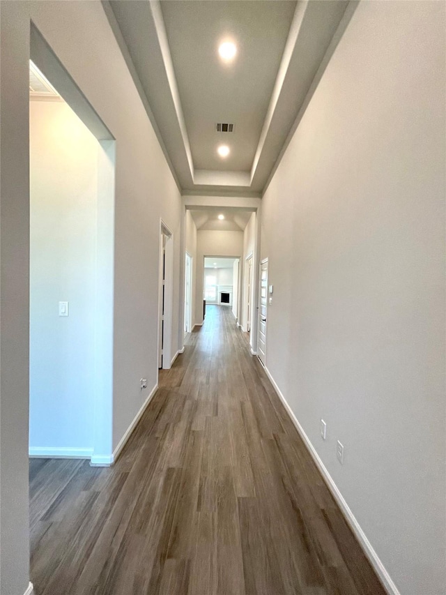 669 Cape Capri Dr, Katy, TX 77493 - hallway featuring dark wood-type flooring, a tray ceiling, and recessed lighting