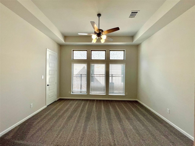 669 Cape Capri Dr, Katy, TX 77493 - spare room featuring ceiling fan, dark carpet, and a raised ceiling