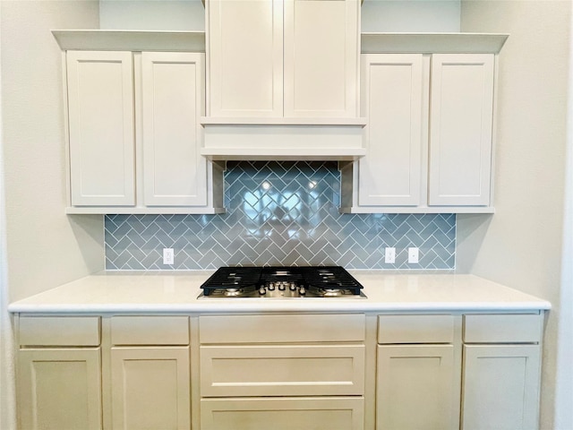 669 Cape Capri Dr, Katy, TX 77493 - kitchen featuring stainless steel gas cooktop, backsplash, light countertops, and custom exhaust hood