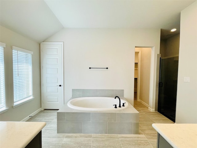 669 Cape Capri Dr, Katy, TX 77493 - full bath with a bath, vanity, a shower stall, tile patterned floors, and vaulted ceiling