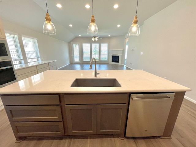669 Cape Capri Dr, Katy, TX 77493 - kitchen with stainless steel appliances, light wood-style flooring, open floor plan, ceiling fan, and recessed lighting