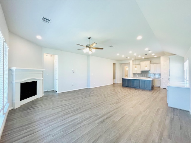 669 Cape Capri Dr, Katy, TX 77493 - unfurnished living room featuring a ceiling fan, light wood-style floors, recessed lighting, a fireplace, and lofted ceiling