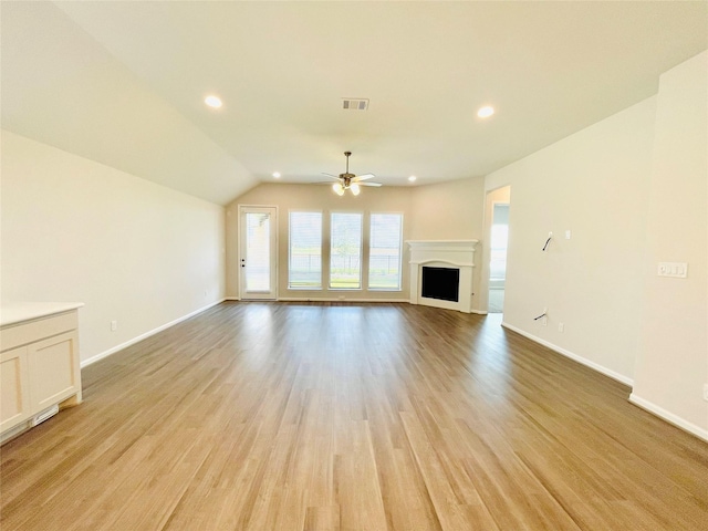 669 Cape Capri Dr, Katy, TX 77493 - unfurnished living room with ceiling fan, light wood-style floors, vaulted ceiling, a fireplace, and recessed lighting