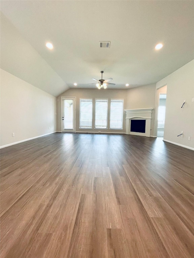 669 Cape Capri Dr, Katy, TX 77493 - unfurnished living room with a ceiling fan, wood finished floors, lofted ceiling, a fireplace, and recessed lighting