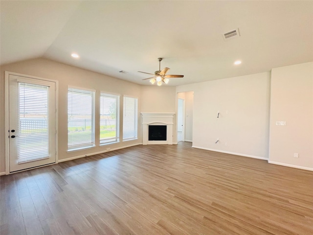669 Cape Capri Dr, Katy, TX 77493 - unfurnished living room featuring healthy amount of natural light, a ceiling fan, light wood-style flooring, lofted ceiling, and a fireplace