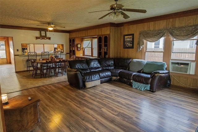 103 Birch St, Wallis, TX 77485 - living area with ceiling fan, cooling unit, wood finished floors, crown molding, and wood walls