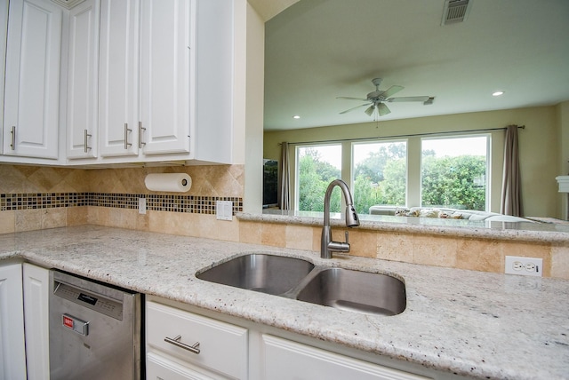 1006 Pointe Loma Dr, Sugar Land, TX 77479 - kitchen featuring stainless steel dishwasher, white cabinetry, plenty of natural light, tasteful backsplash, and recessed lighting