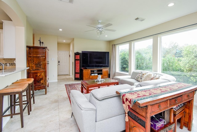 1006 Pointe Loma Dr, Sugar Land, TX 77479 - living area with a ceiling fan, recessed lighting, and arched walkways