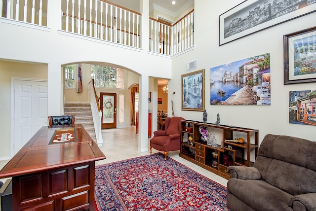 1006 Pointe Loma Dr, Sugar Land, TX 77479 - tiled living area featuring arched walkways, stairs, ornamental molding, and a high ceiling