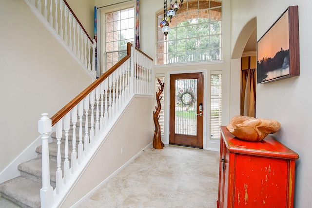 1006 Pointe Loma Dr, Sugar Land, TX 77479 - foyer entrance with a towering ceiling, arched walkways, and stairs