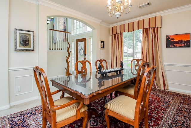 1006 Pointe Loma Dr, Sugar Land, TX 77479 - dining room with a chandelier, crown molding, plenty of natural light, a decorative wall, and wainscoting