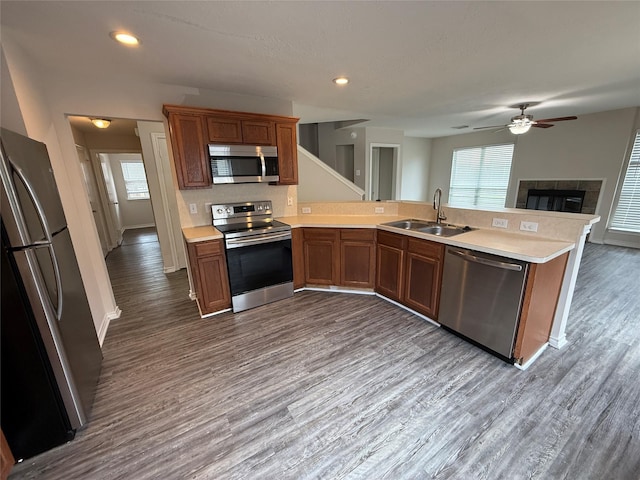 2325 Shady Tree Ln, Conroe, TX 77301 - kitchen with stainless steel appliances, dark wood-style floors, light countertops, a ceiling fan, and recessed lighting