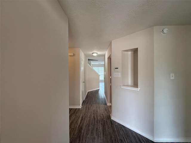 2325 Shady Tree Ln, Conroe, TX 77301 - hall with dark wood-style floors and a textured ceiling