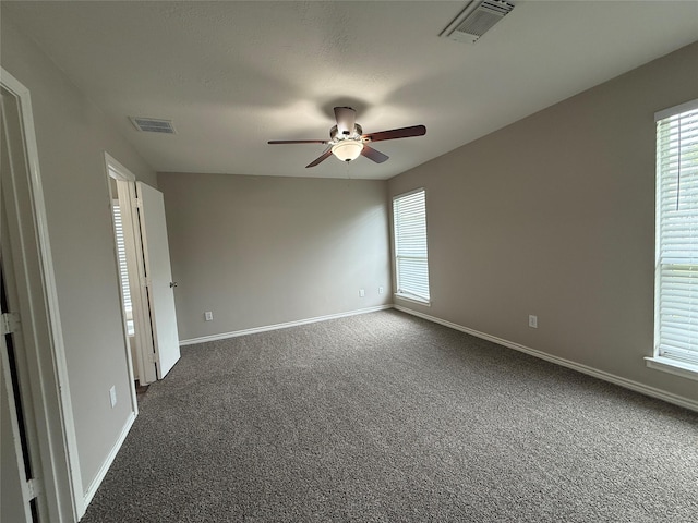 2325 Shady Tree Ln, Conroe, TX 77301 - spare room with ceiling fan, plenty of natural light, and dark carpet