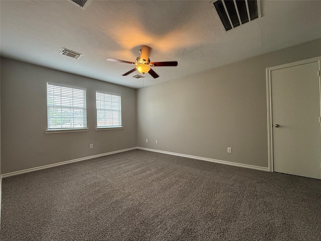 2325 Shady Tree Ln, Conroe, TX 77301 - empty room featuring a ceiling fan, dark carpet, and a textured ceiling