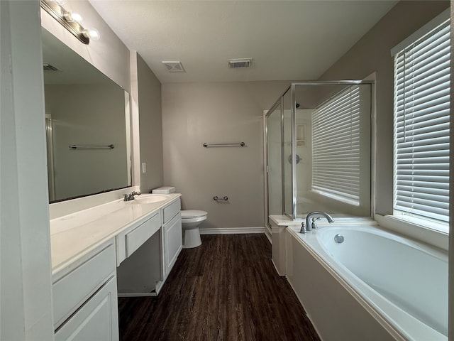 2325 Shady Tree Ln, Conroe, TX 77301 - bathroom with vanity, a stall shower, wood finished floors, and a garden tub