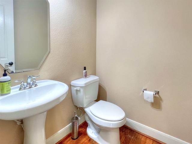 2325 Hutchins St, Houston, TX 77004 - half bathroom with wood finished floors and toilet