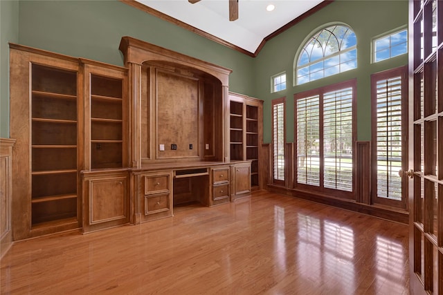 16506 Emilia Ct, Spring, TX 77379 - unfurnished office featuring ornamental molding, light wood-style floors, ceiling fan, built in desk, and lofted ceiling