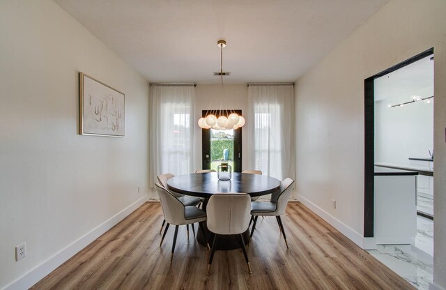 4426 Innsbrook Pl, Sugar Land, TX 77479 - dining space with a chandelier and light wood-style flooring