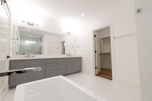 1202 Hamblen St, Houston, TX 77009 - full bath featuring a stall shower, double vanity, a soaking tub, recessed lighting, and a spacious closet