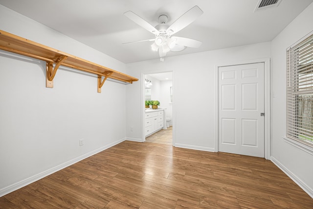 2206 Hollow Bloom Ln, Katy, TX 77494 - unfurnished bedroom with wood finished floors, ceiling fan, and ensuite bathroom
