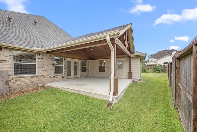 2206 Hollow Bloom Ln, Katy, TX 77494 - rear view of house with a shingled roof, french doors, a patio area, a fenced backyard, and brick siding