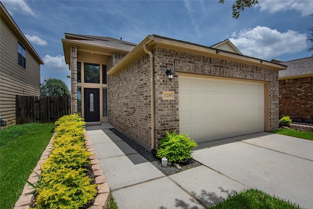 8218 Rustic Cape Dr, Cypress, TX 77433 - view of front of house with brick siding, concrete driveway, and a garage