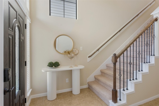 8218 Rustic Cape Dr, Cypress, TX 77433 - entryway featuring stairs and light tile patterned floors