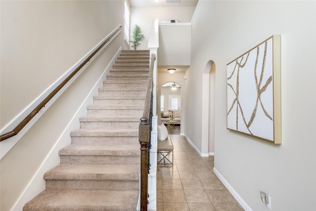 8218 Rustic Cape Dr, Cypress, TX 77433 - stairs with arched walkways and tile patterned floors