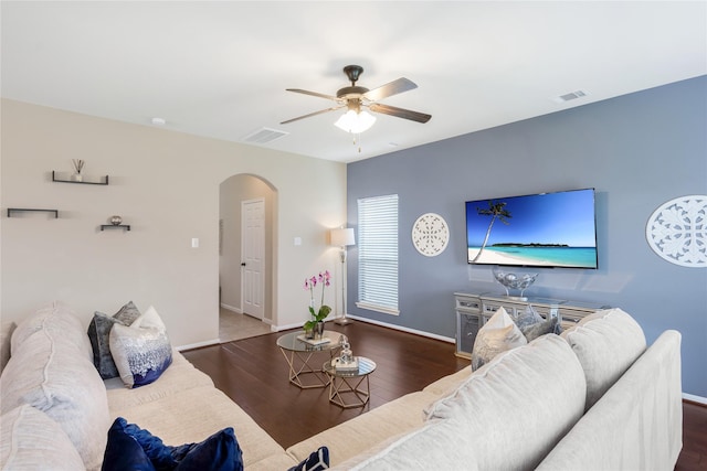 8218 Rustic Cape Dr, Cypress, TX 77433 - living room featuring arched walkways, a ceiling fan, and wood finished floors