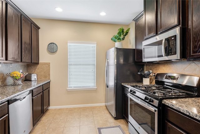 8218 Rustic Cape Dr, Cypress, TX 77433 - kitchen with stainless steel appliances, dark brown cabinetry, light stone counters, decorative backsplash, and recessed lighting