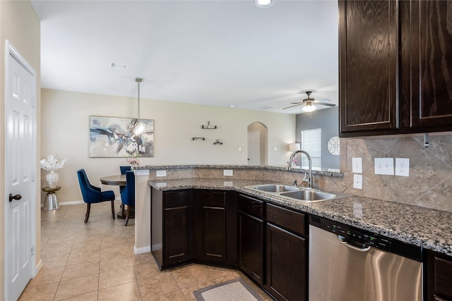 8218 Rustic Cape Dr, Cypress, TX 77433 - kitchen with dishwasher, arched walkways, dark brown cabinets, ceiling fan, and light tile patterned floors