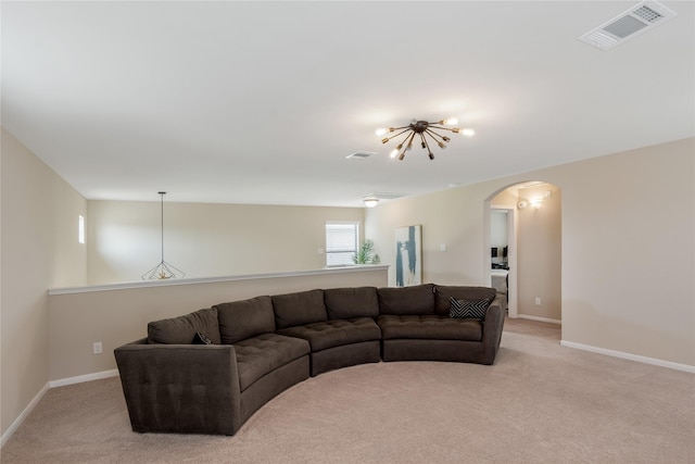 8218 Rustic Cape Dr, Cypress, TX 77433 - living area featuring arched walkways, light colored carpet, and a chandelier