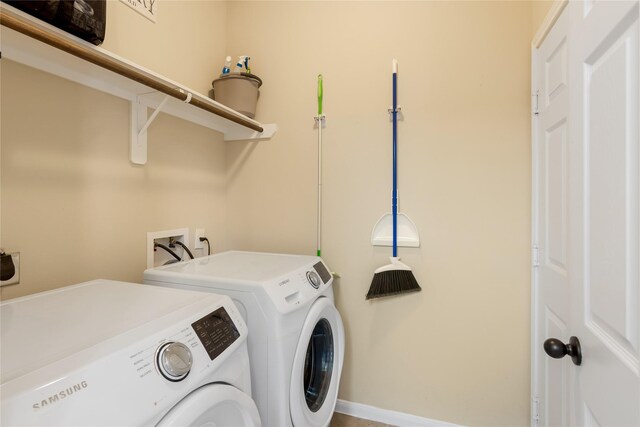 8218 Rustic Cape Dr, Cypress, TX 77433 - laundry area featuring washing machine and clothes dryer and baseboards
