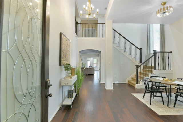 8106 Yarrow Dr, Cypress, TX 77433 - foyer with a chandelier, arched walkways, wood finished floors, stairway, and a high ceiling