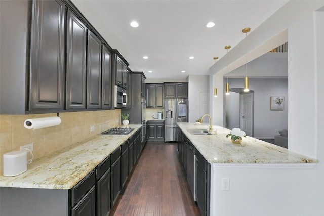 8106 Yarrow Dr, Cypress, TX 77433 - kitchen with stainless steel appliances, dark wood-style floors, light stone counters, tasteful backsplash, and recessed lighting