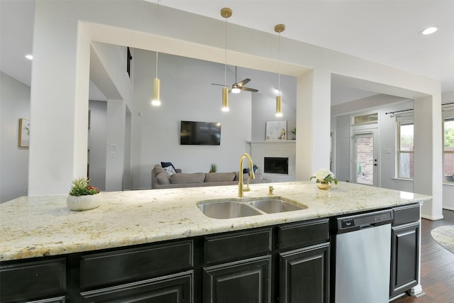 8106 Yarrow Dr, Cypress, TX 77433 - kitchen featuring stainless steel dishwasher, open floor plan, dark cabinetry, light stone counters, and recessed lighting