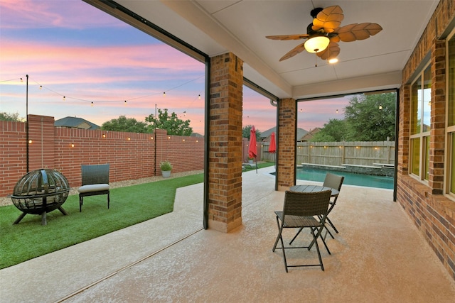8106 Yarrow Dr, Cypress, TX 77433 - patio terrace at dusk with a fenced backyard, a ceiling fan, and a patio area
