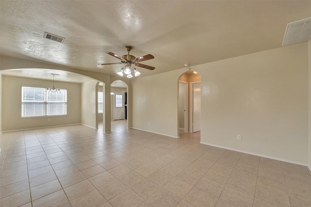 12807 Maybank Shores Ct, Houston, TX 77045 - empty room featuring arched walkways, a ceiling fan, light tile patterned floors, a textured ceiling, and a chandelier