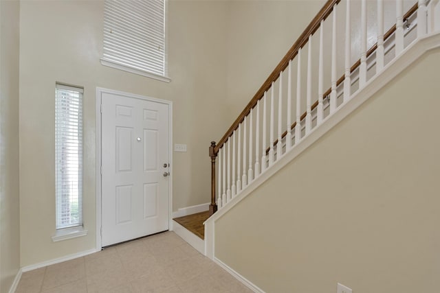 12807 Maybank Shores Ct, Houston, TX 77045 - entrance foyer featuring a towering ceiling, stairs, plenty of natural light, and tile patterned floors