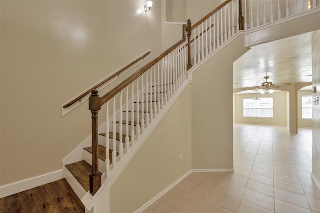 12807 Maybank Shores Ct, Houston, TX 77045 - stairs featuring ceiling fan and tile patterned floors