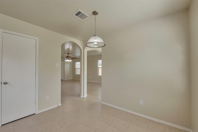 12807 Maybank Shores Ct, Houston, TX 77045 - spare room featuring arched walkways, ceiling fan, and light tile patterned floors