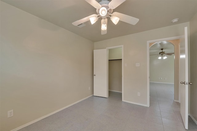 12807 Maybank Shores Ct, Houston, TX 77045 - unfurnished bedroom featuring light tile patterned floors, ceiling fan, and a spacious closet
