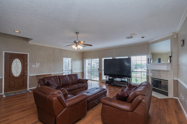 2601 Sailboat Dr, Houston, TX 77058 - living room with a textured ceiling, wood finished floors, ceiling fan, a high end fireplace, and crown molding