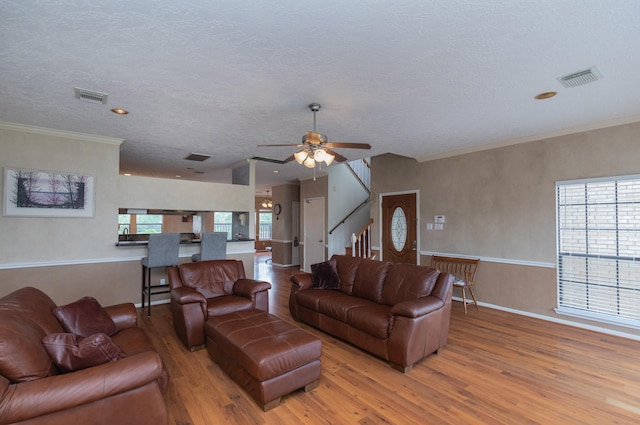2601 Sailboat Dr, Houston, TX 77058 - living area featuring wood finished floors, ceiling fan, stairway, a textured ceiling, and ornamental molding