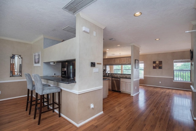 2601 Sailboat Dr, Houston, TX 77058 - kitchen featuring dishwasher, a textured ceiling, dark wood finished floors, black fridge with ice dispenser, and a kitchen bar