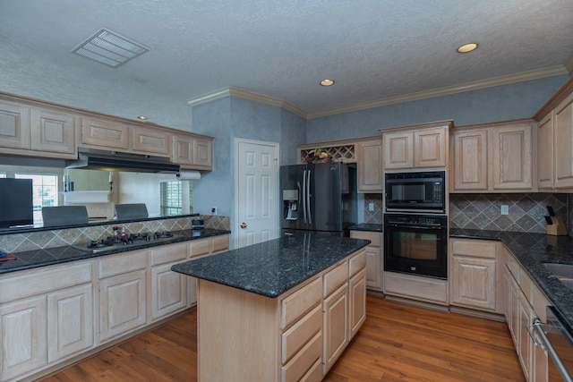 2601 Sailboat Dr, Houston, TX 77058 - kitchen featuring black appliances, under cabinet range hood, wood finished floors, backsplash, and light brown cabinets